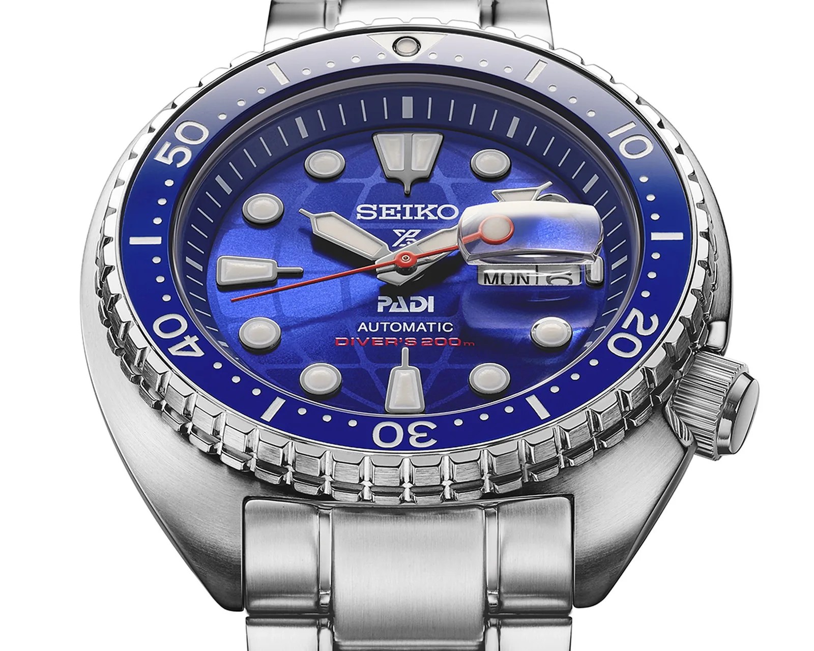 Stainless steel Seiko automatic diver's watch with blue dial, luminous markers, and date magnifier.