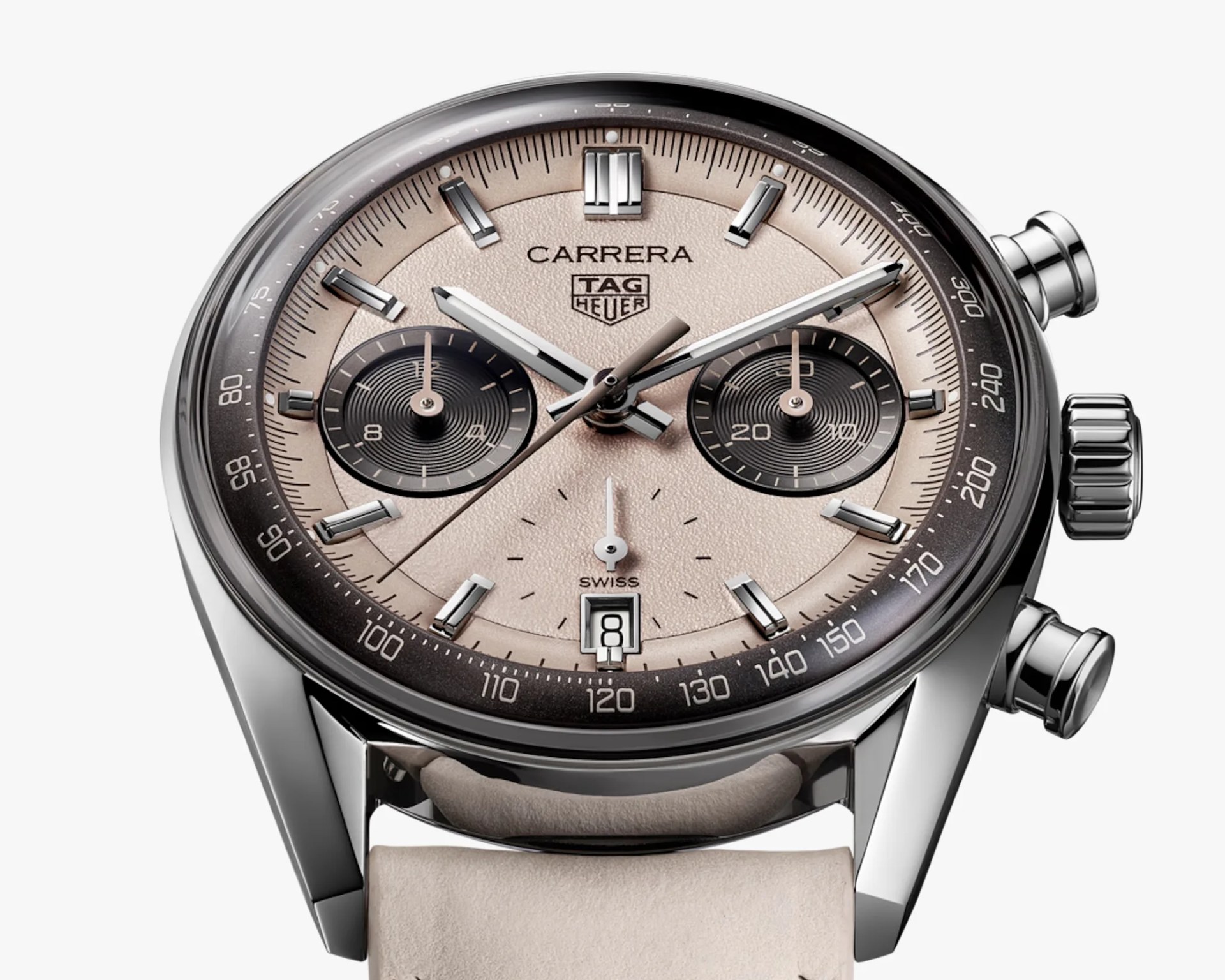 Close-up of a TAG Heuer Carrera watch with a beige dial, black subdials, silver markers, and a beige leather strap.