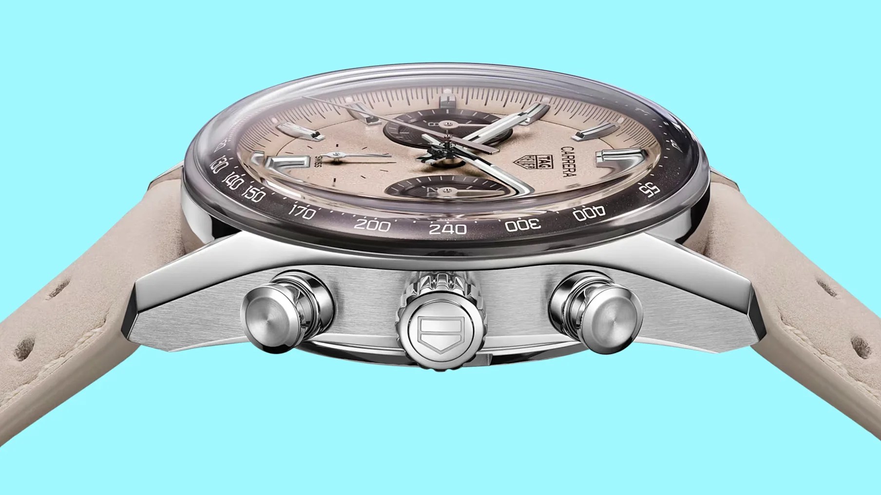 Silver TAG Heuer Carrera chronograph watch with beige dial and matching beige leather strap on blue background.
