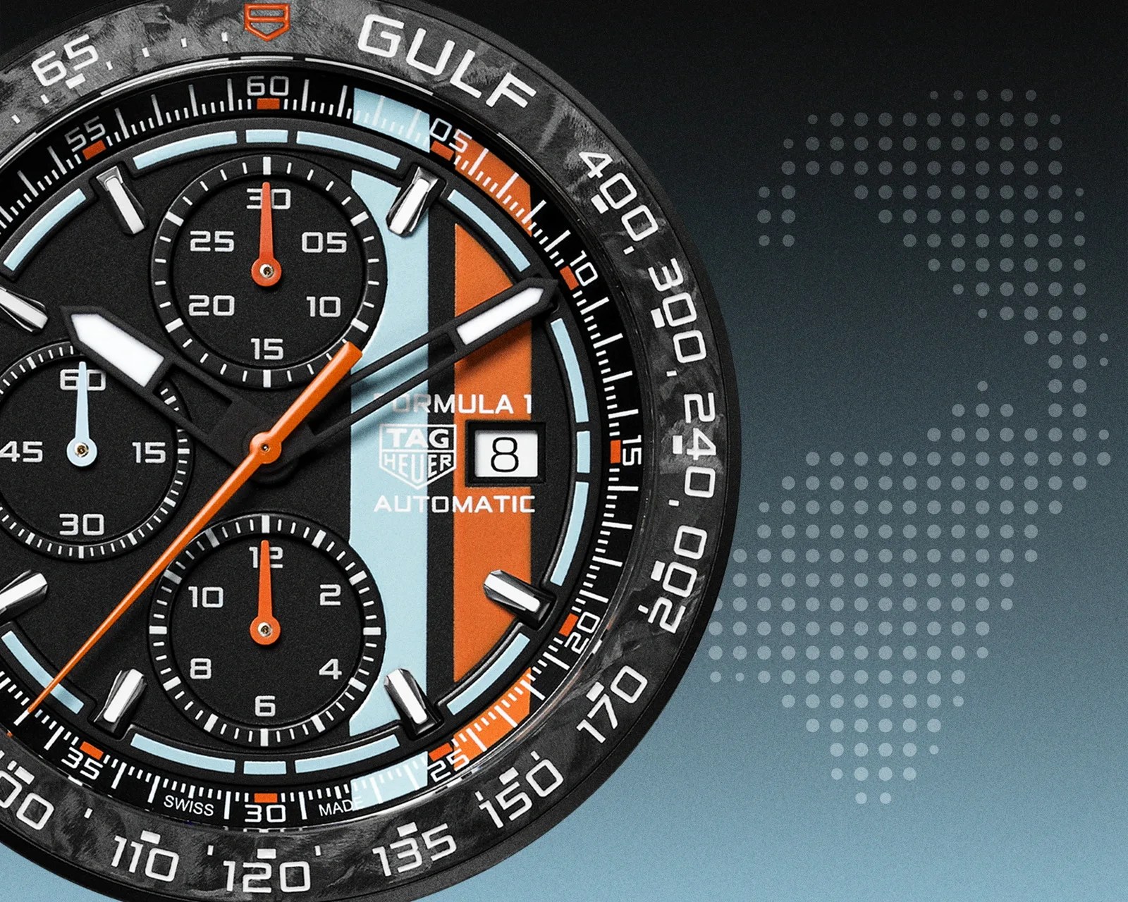 Close-up of a TAG Heuer Formula 1 Gulf Automatic watch face with black, light blue, and orange accents and three subdials.