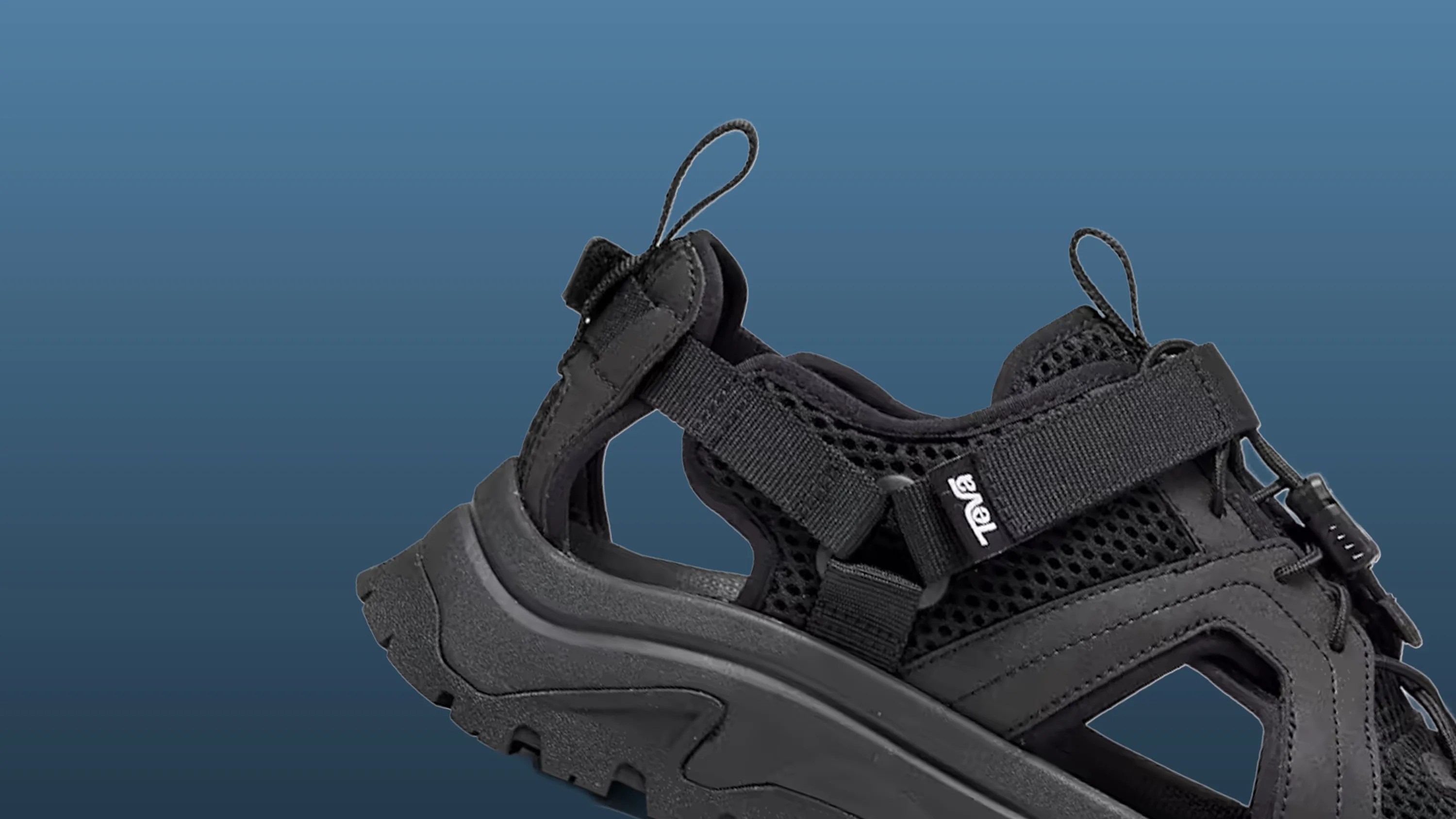 Black Teva sandal with mesh upper, adjustable straps, and rugged sole on a blue background.