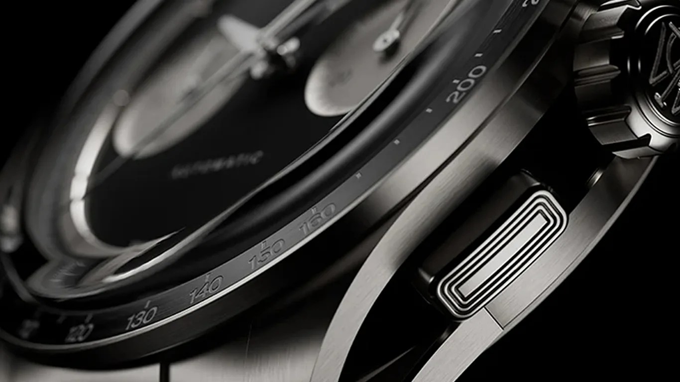 Close-up of a titanium watch bezel and side pusher with engraved tachymeter scale markings.
