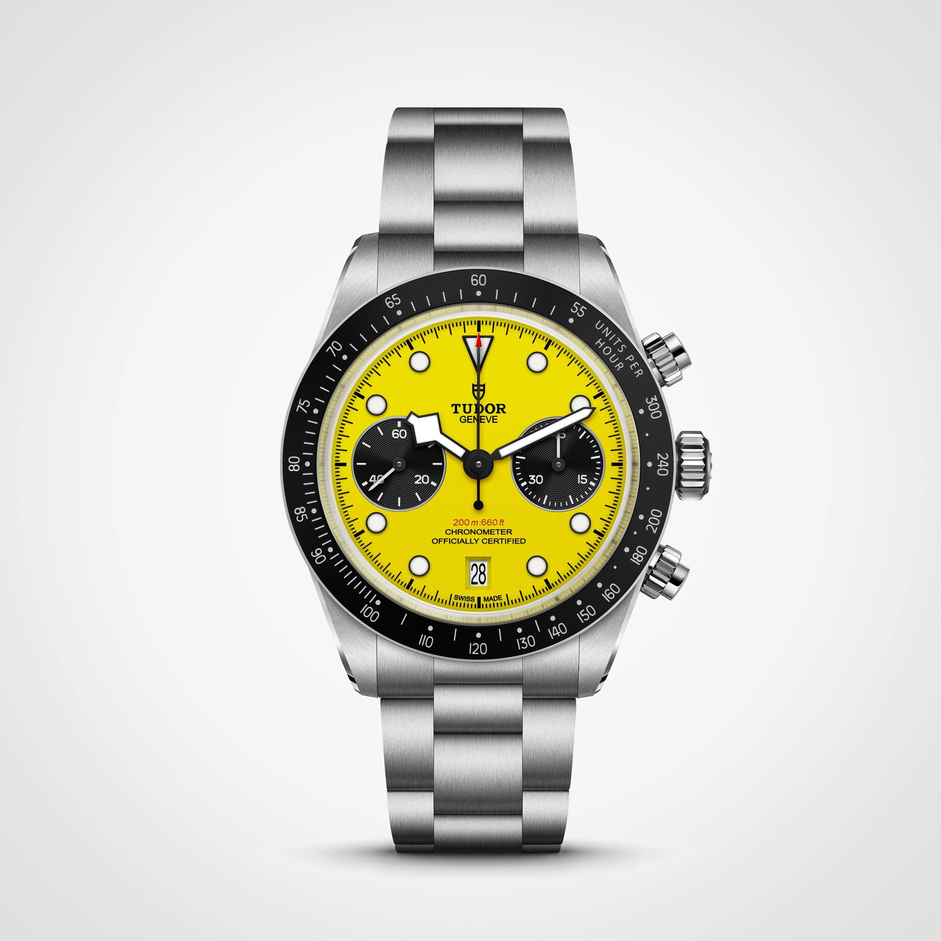 Stainless steel Tudor chronograph watch with bright yellow dial, black subdials, and black bezel on a metal bracelet.