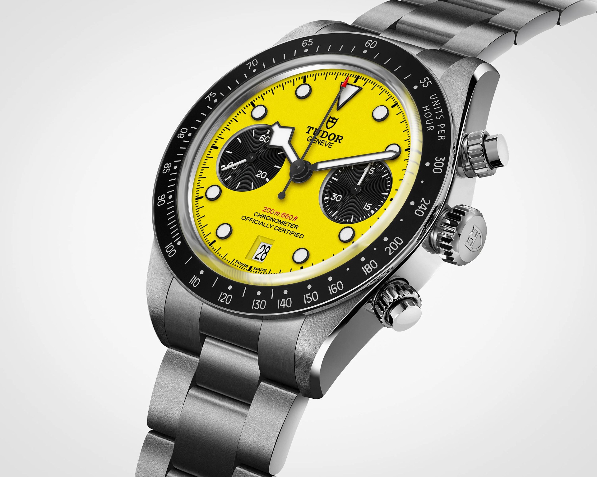 Stainless steel Tudor chronograph watch with bright yellow dial, black subdials, and black bezel with tachymeter scale.