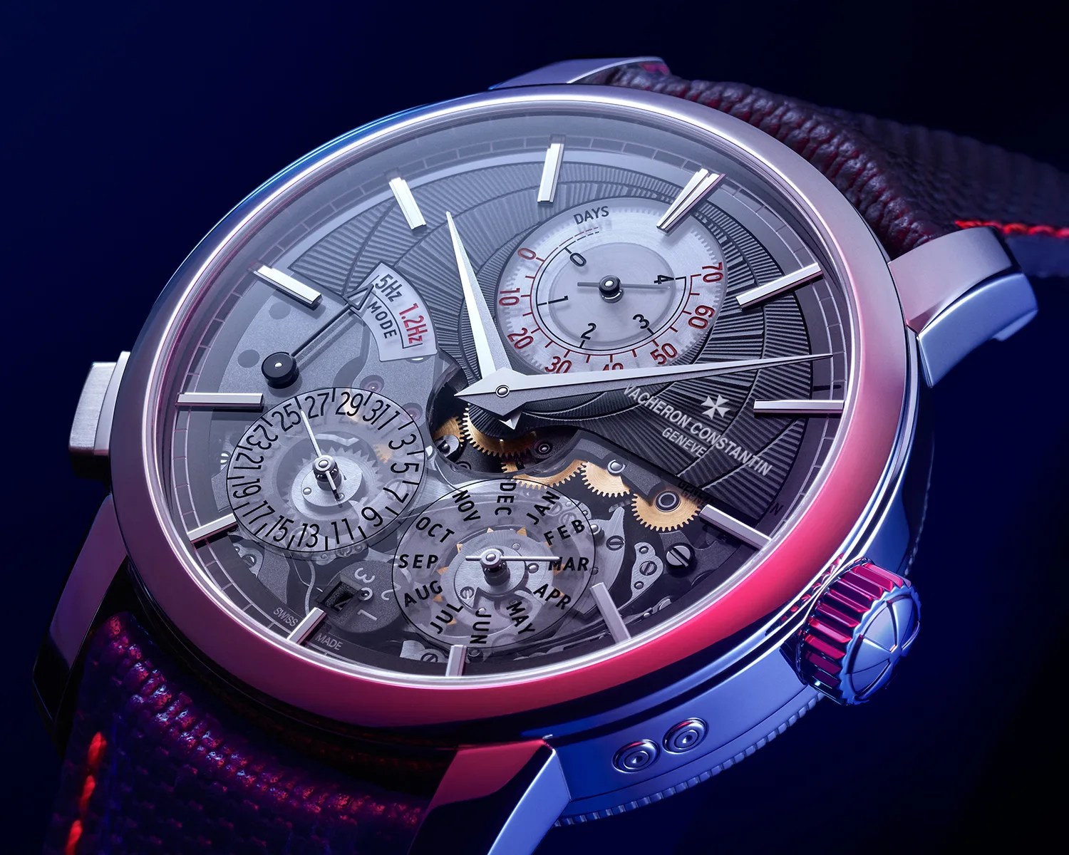 Close-up of a Vacheron Constantin wristwatch with a transparent dial showing gears, date, month, and power reserve indicators.