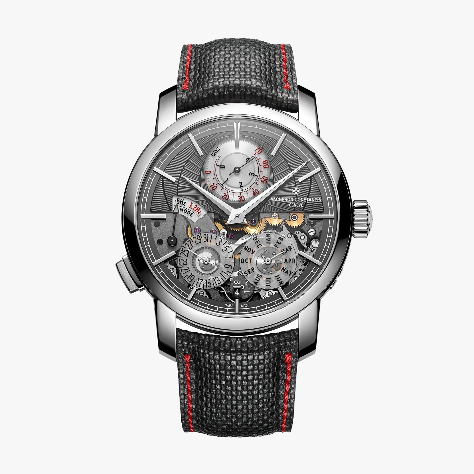 Silver Vacheron Constantin wristwatch with a textured black strap featuring red stitching and a detailed mechanical dial.