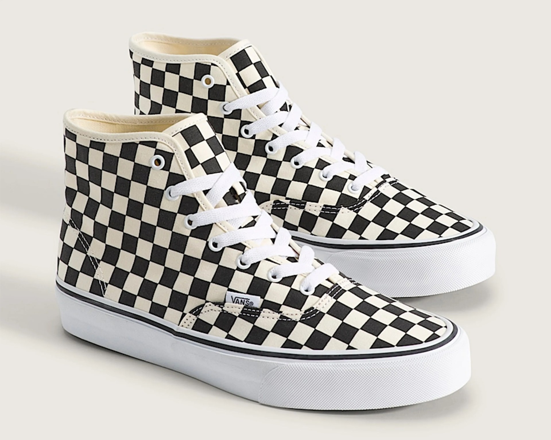 High-top Vans sneakers with black and white checkerboard pattern and white laces.