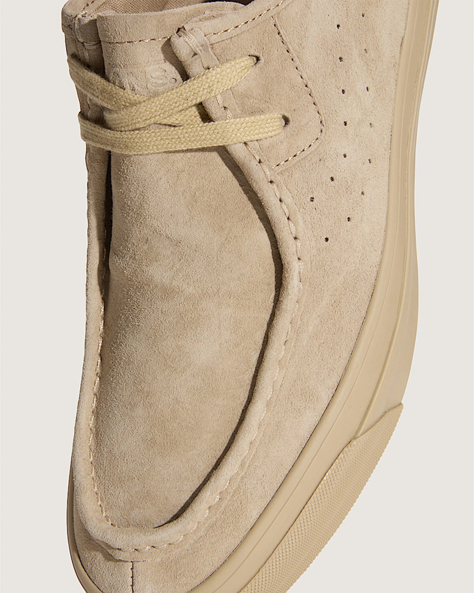 Beige suede shoe with beige laces and a beige rubber sole.