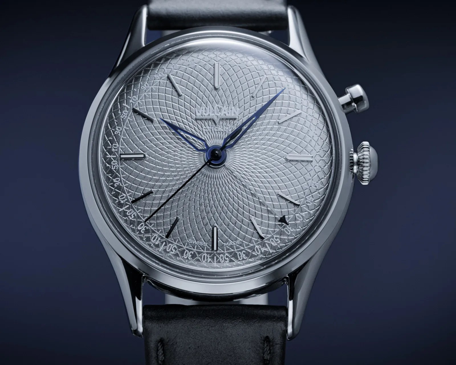 Silver Vulcain wristwatch with intricate guilloché dial, blue hands, black leather strap, and polished stainless steel case.