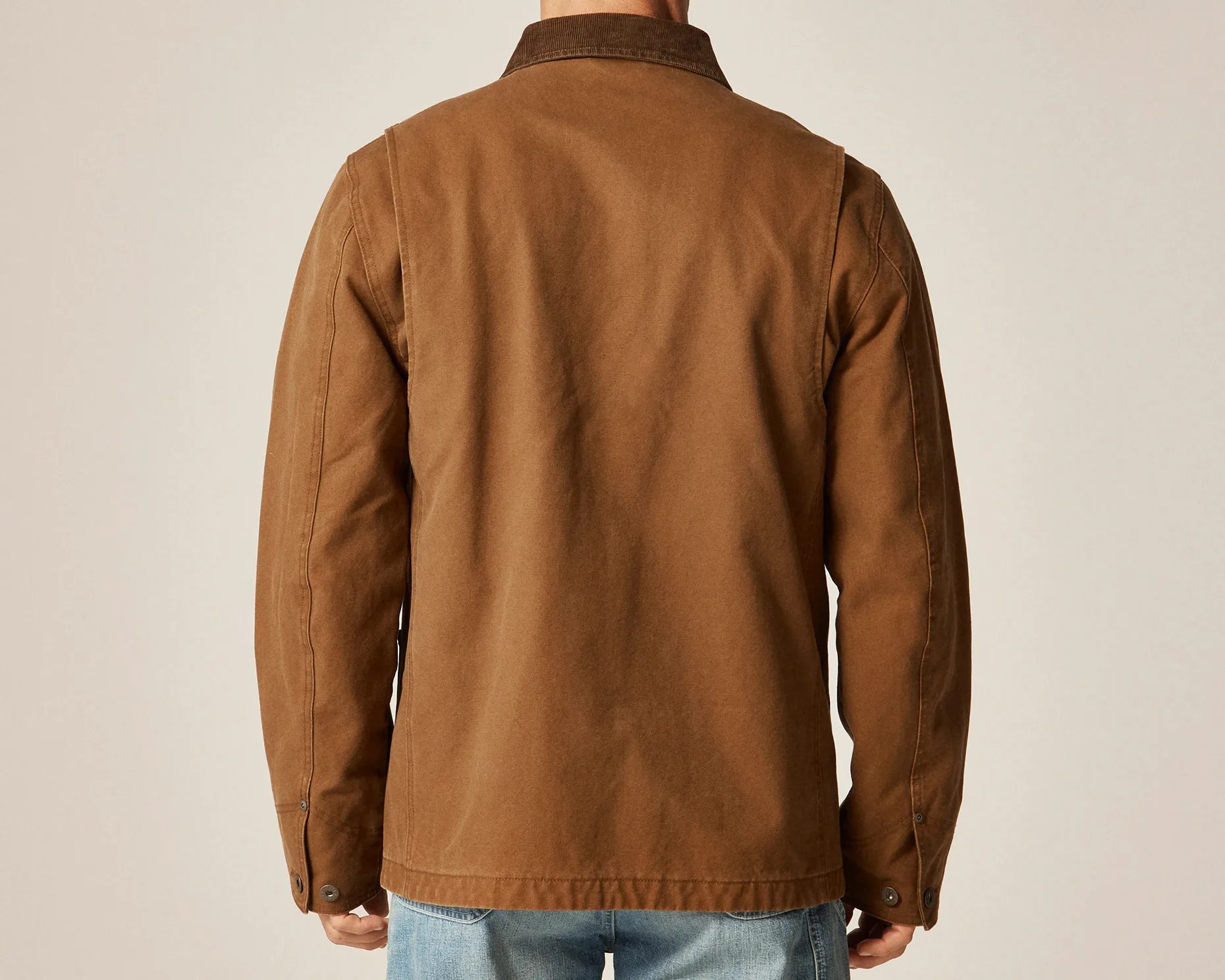 Brown canvas jacket with corduroy collar worn by a person, shown from the back.