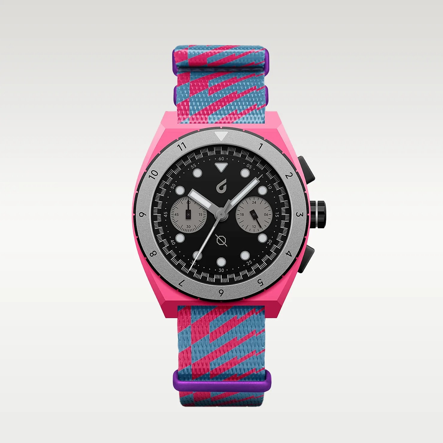 Pink watch with a black dial, silver bezel, and blue and pink patterned fabric strap with purple buckle.