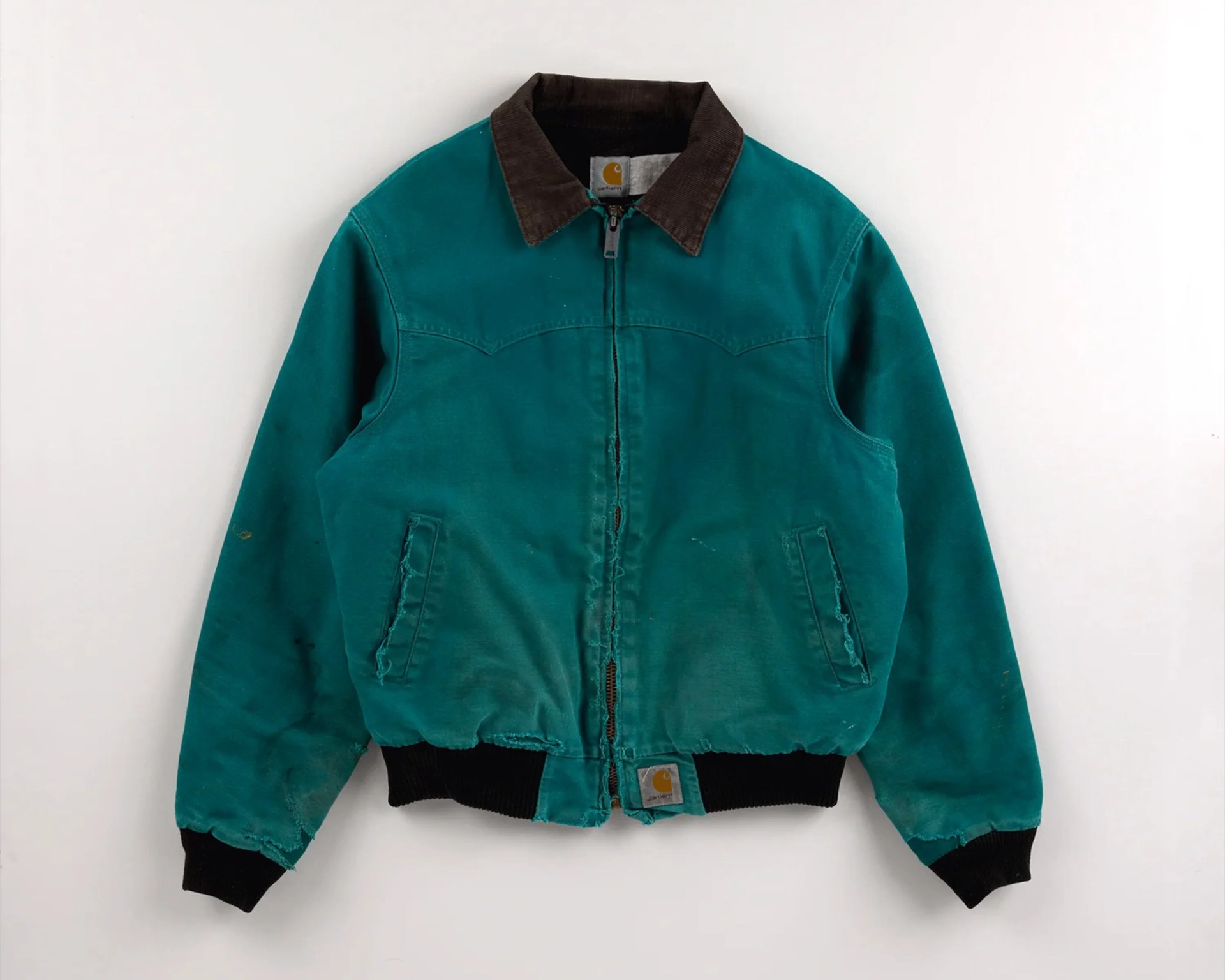 Teal Carhartt jacket with brown corduroy collar and black ribbed cuffs and waistband.