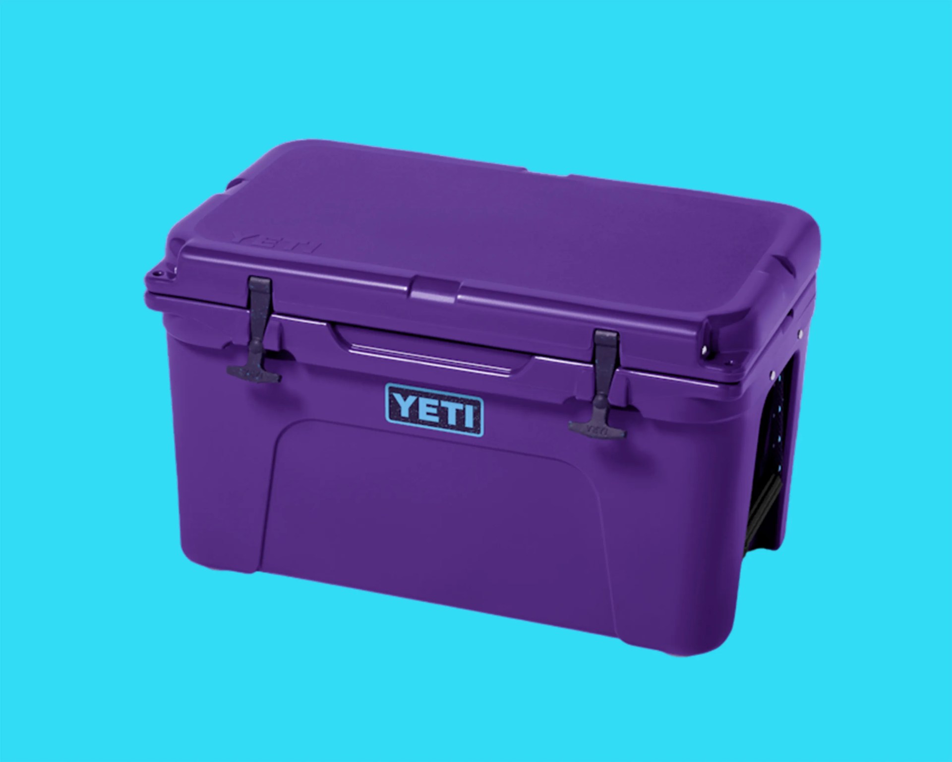 Purple YETI cooler with black latches on a bright blue background.