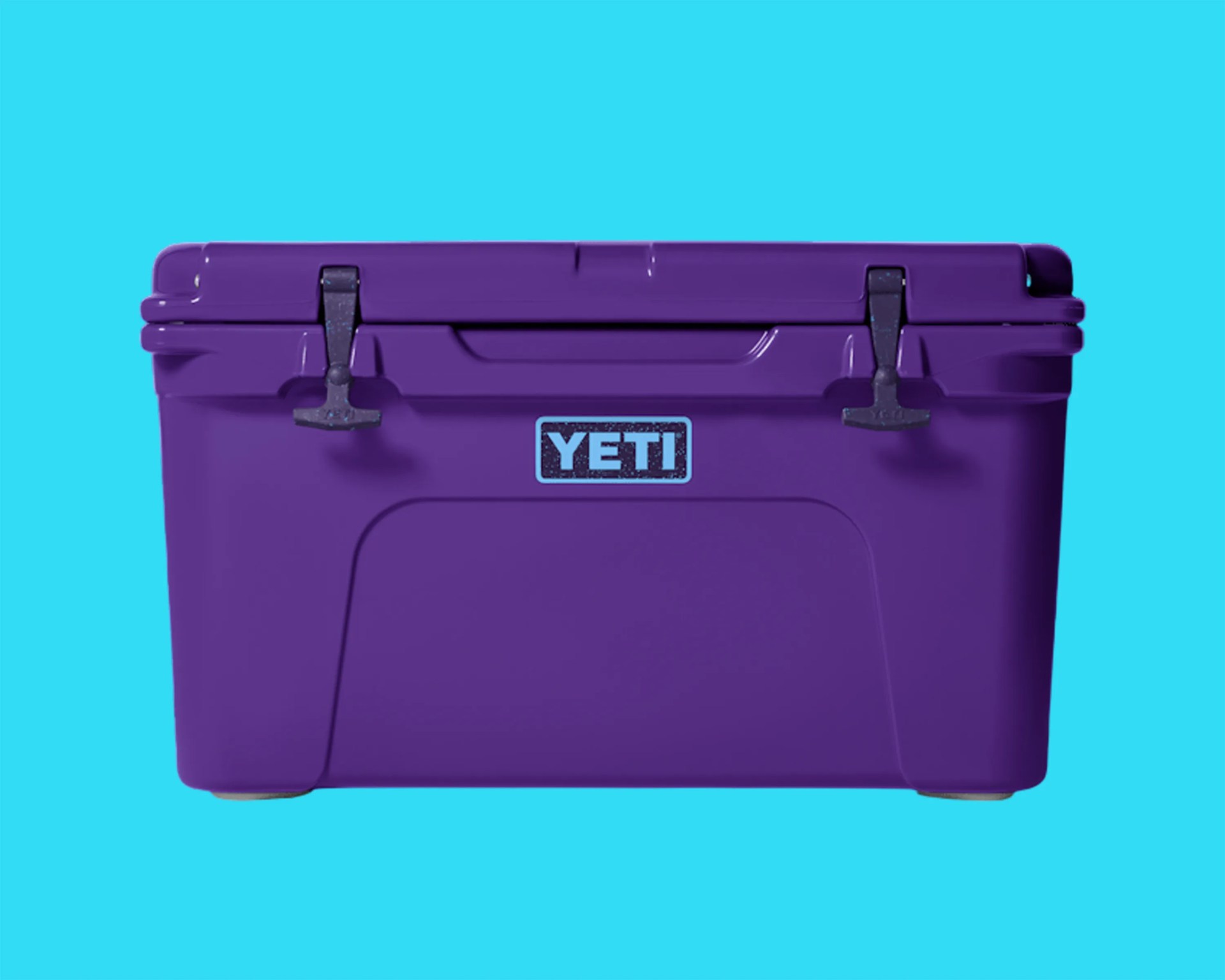 Purple YETI cooler with black latches against a bright blue background.
