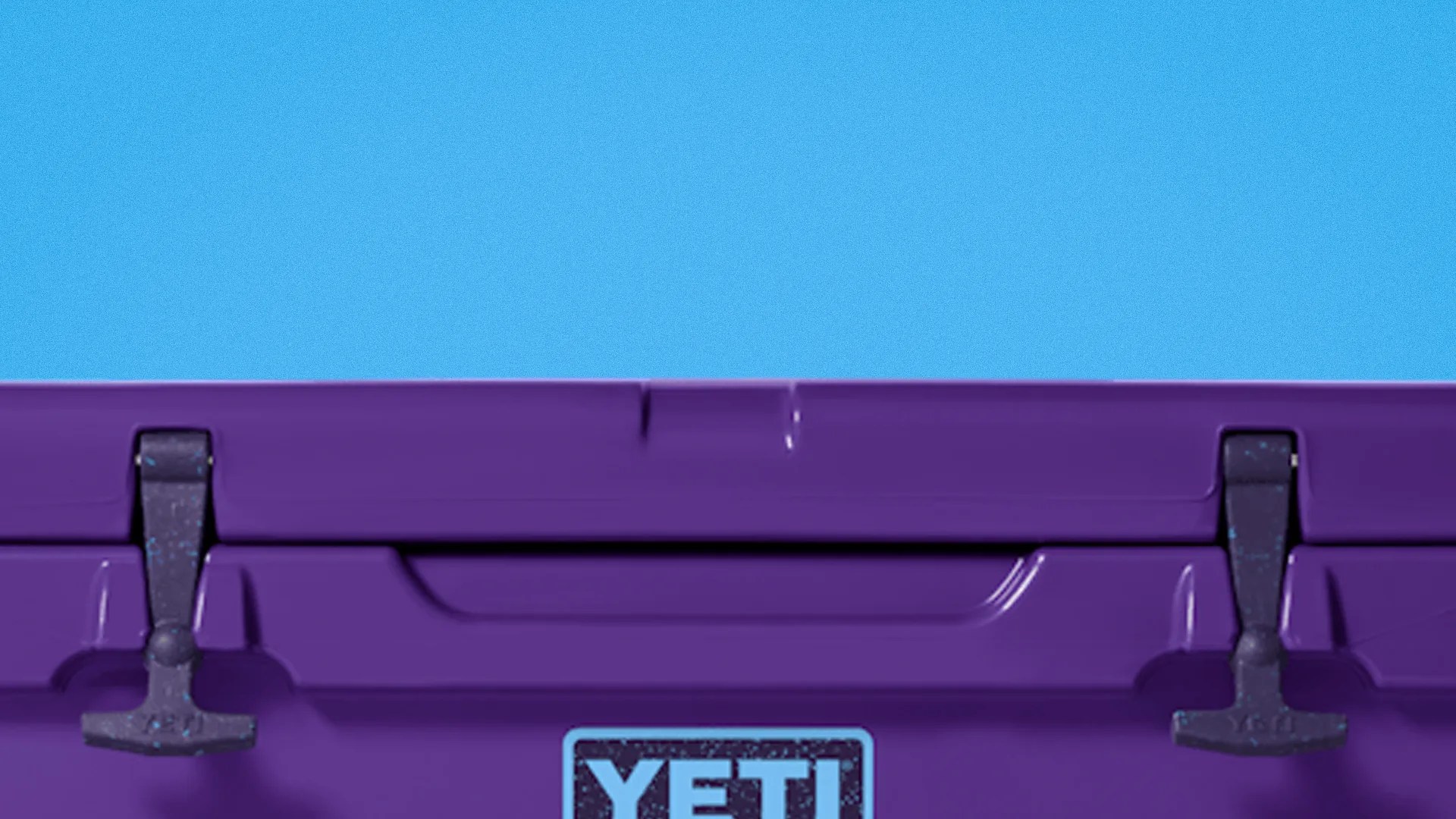 Purple YETI cooler with black latches against a blue background.