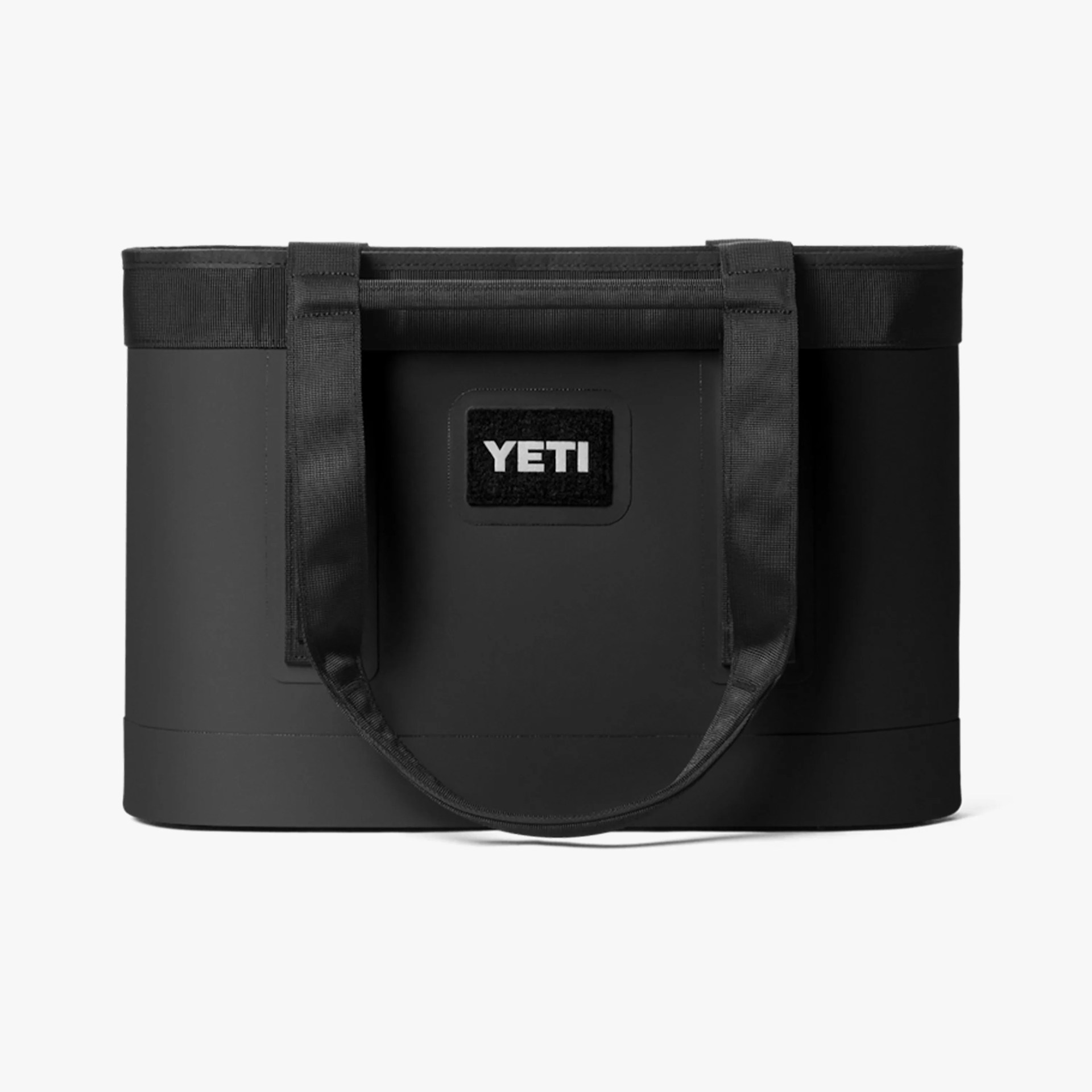 Black YETI tote bag with dual handles and a rectangular logo patch on the front.