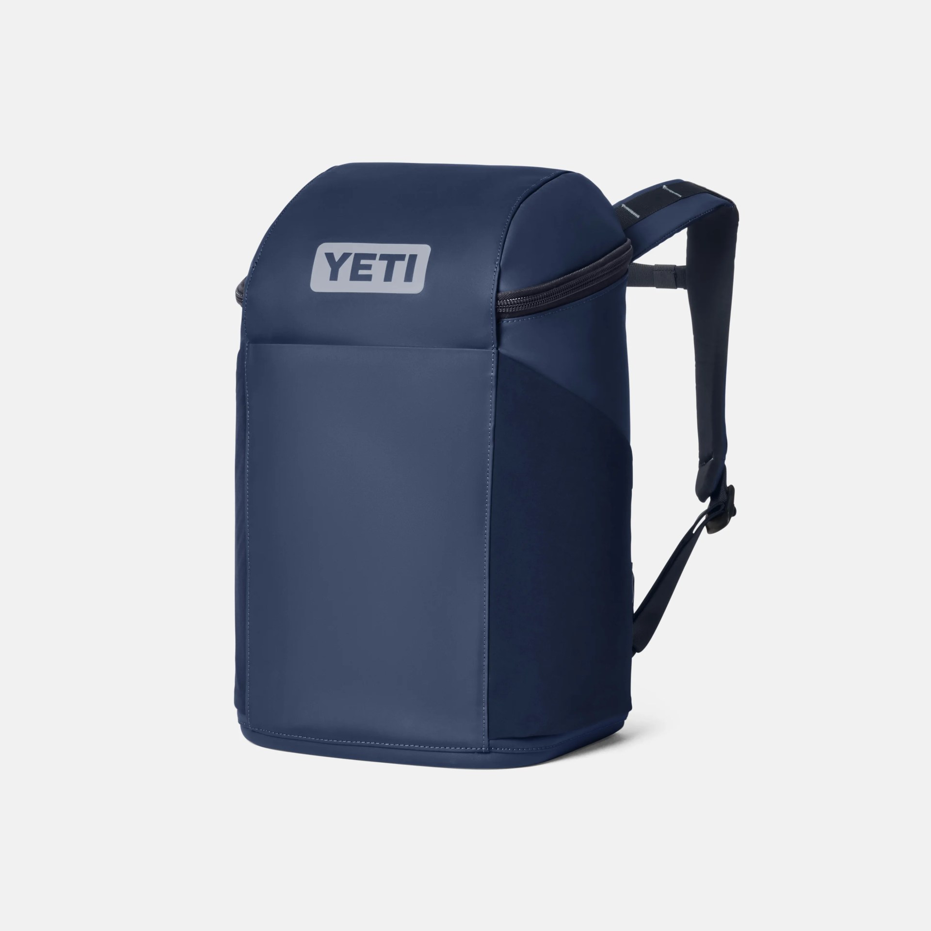 Navy blue YETI backpack with padded shoulder straps and a zippered top section.