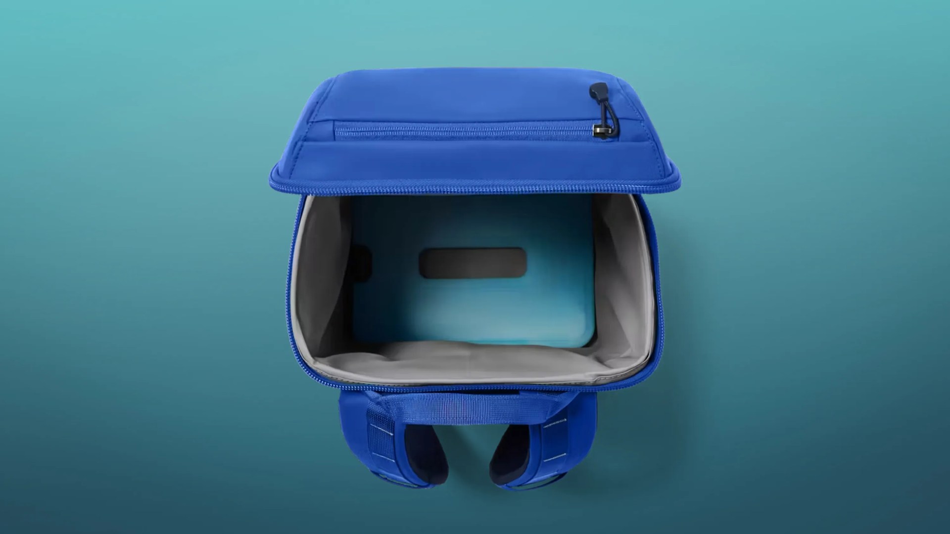 Open blue insulated lunch bag with gray interior lining and zippered top pocket.