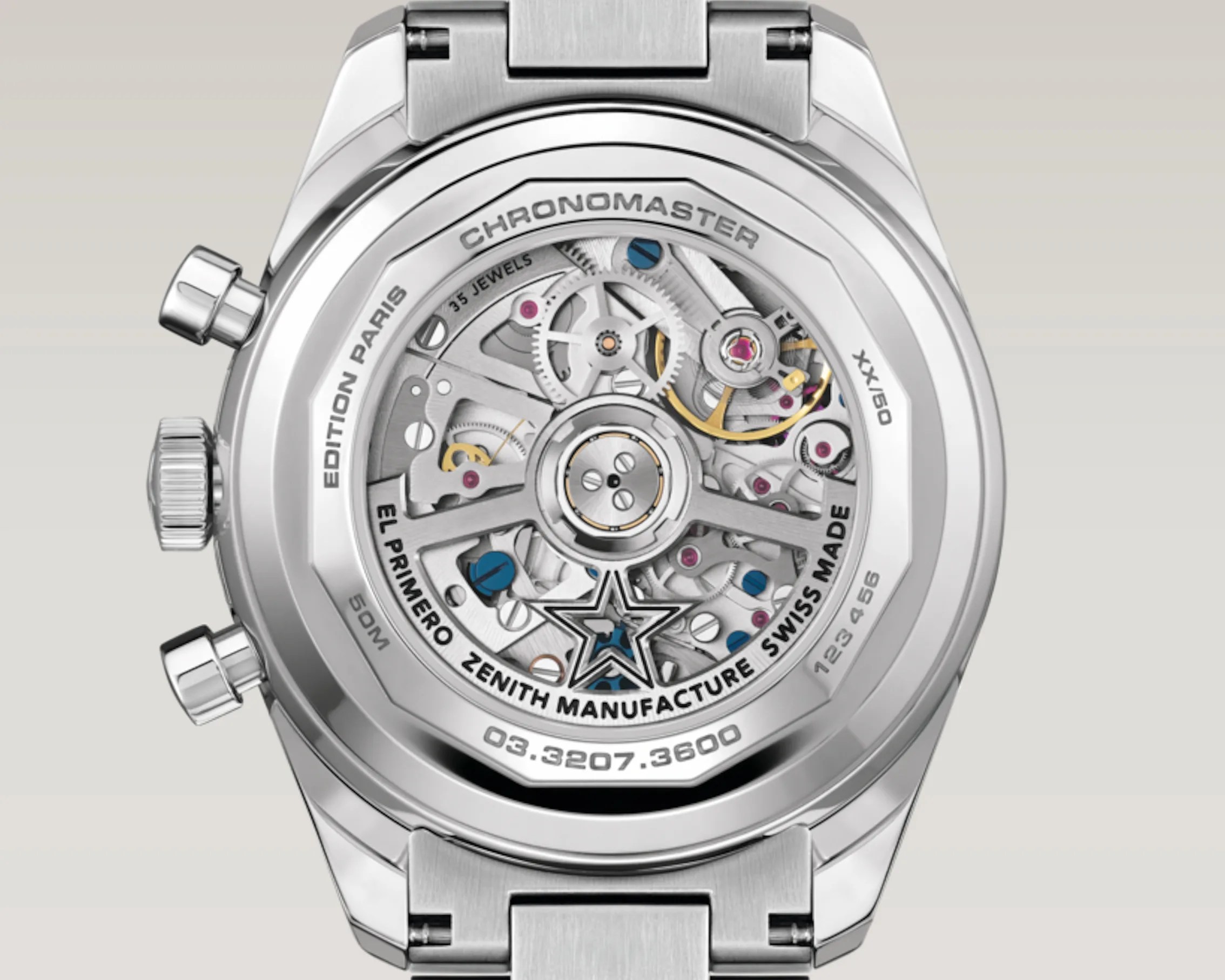 Close-up of the back of a silver Zenith Chronomaster watch showing the intricate El Primero Zenith Manufacture Swiss Made movement with visible gears and jewels.