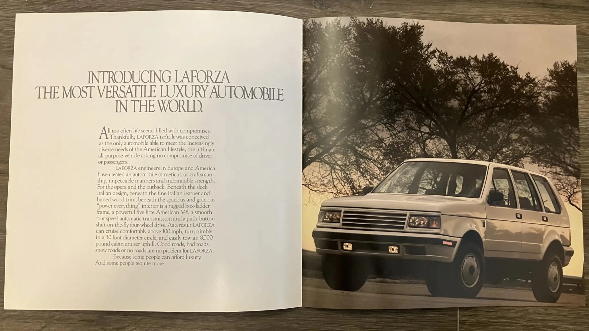 White LaForza SUV parked on a road with trees in the background, shown in a vintage car brochure.