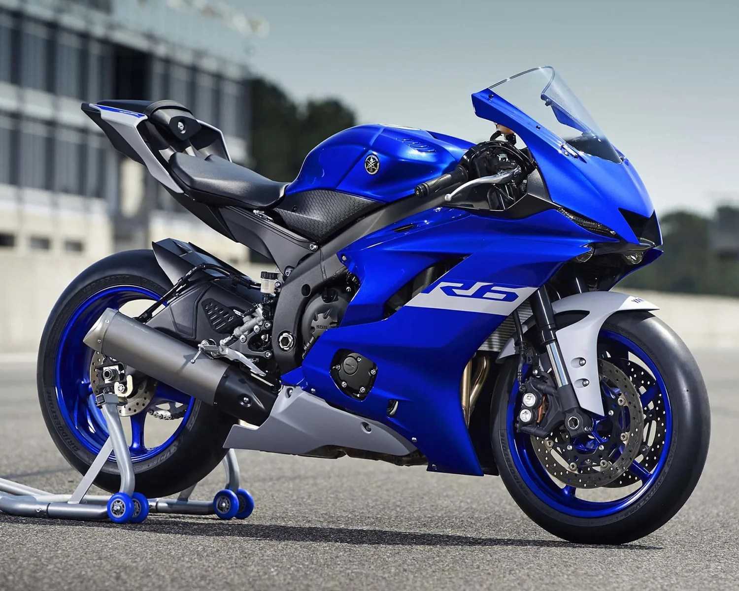 Blue Yamaha R6 sport motorcycle with black and silver accents on a rear stand.