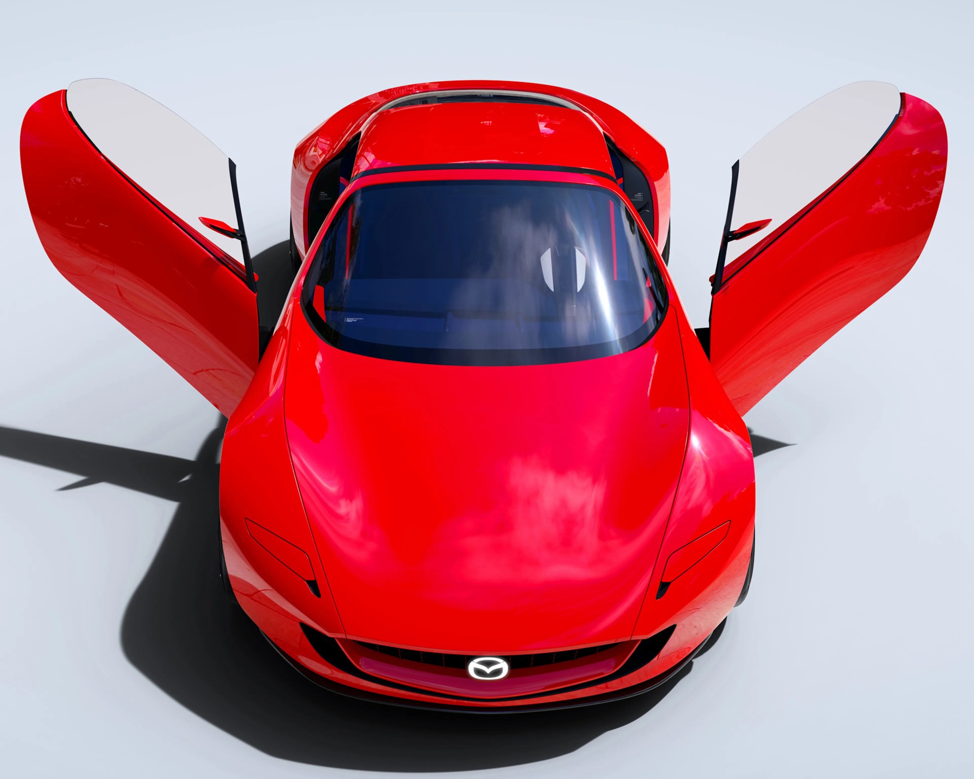 Red Mazda sports car with butterfly doors open, viewed from above on a light background.