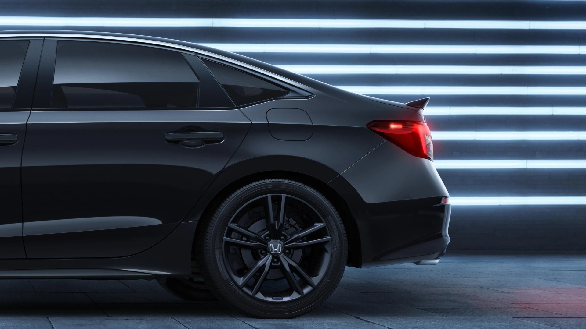 Rear side view of a black Honda sedan with tinted windows and black alloy wheels against a background of horizontal white neon lights.
