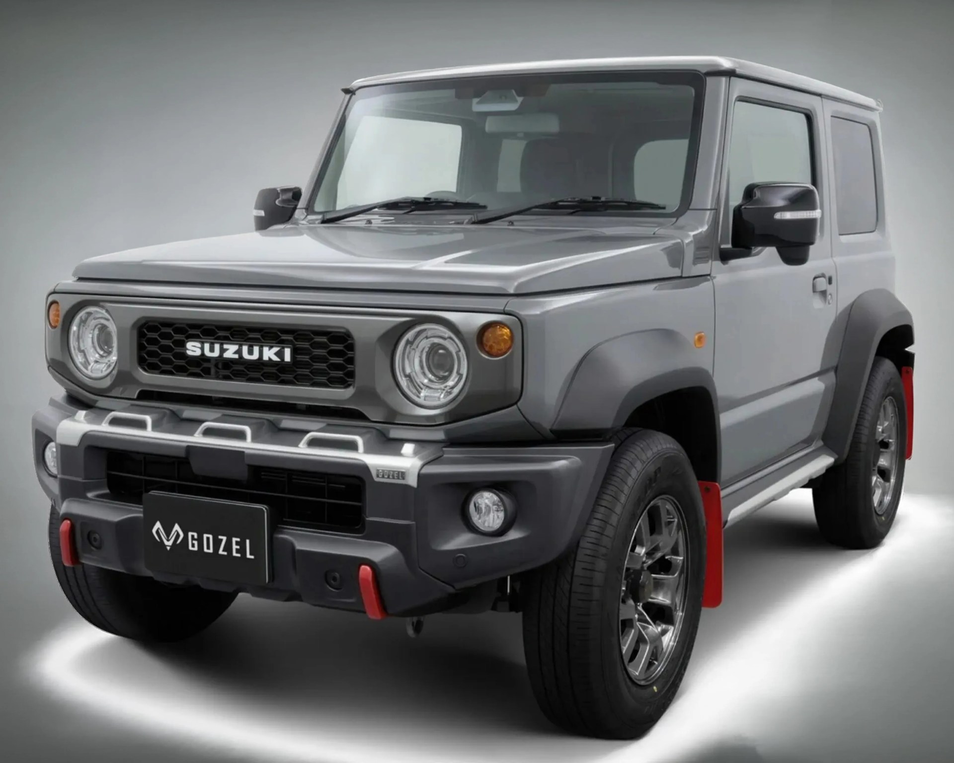 Gray Suzuki SUV with round headlights and red mud flaps on a white background.