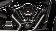 Close-up of a black Milwaukee-Eight 117 cubic inch motorcycle engine with matte and glossy finishes.