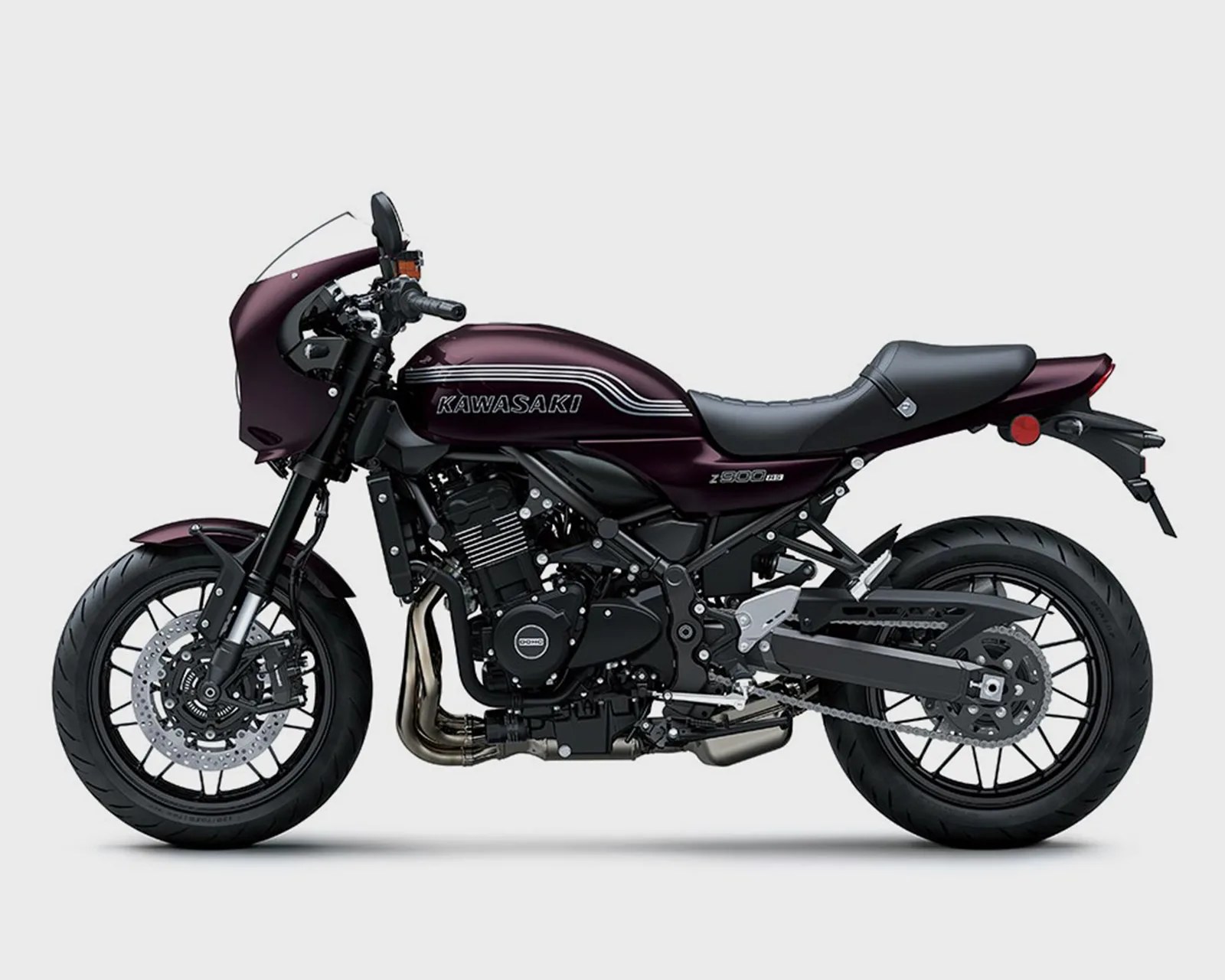 Dark purple Kawasaki Z900RS motorcycle with black seat and black wheels on a white background.