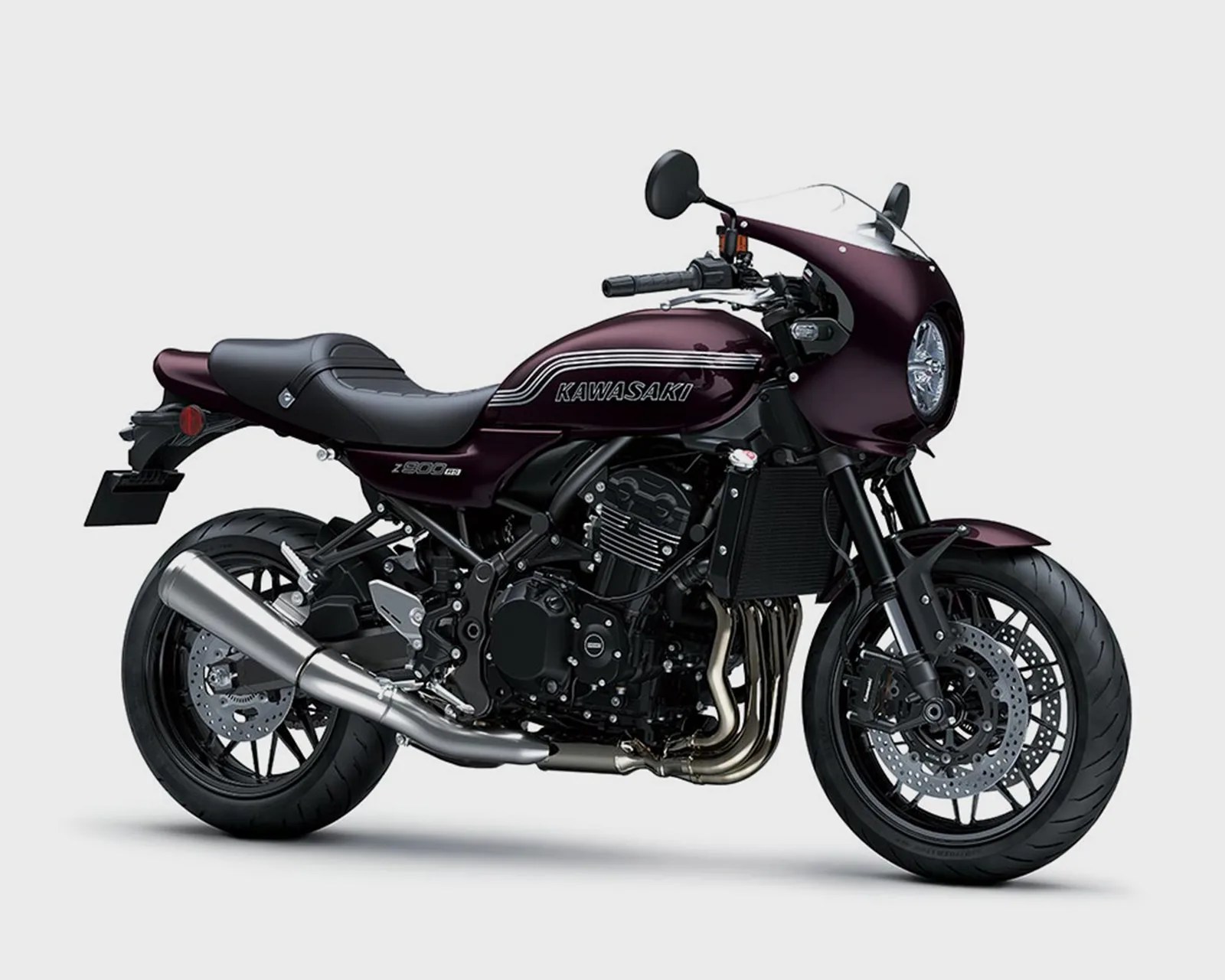 Dark purple Kawasaki Z900RS motorcycle with black seat and silver exhaust on a white background.