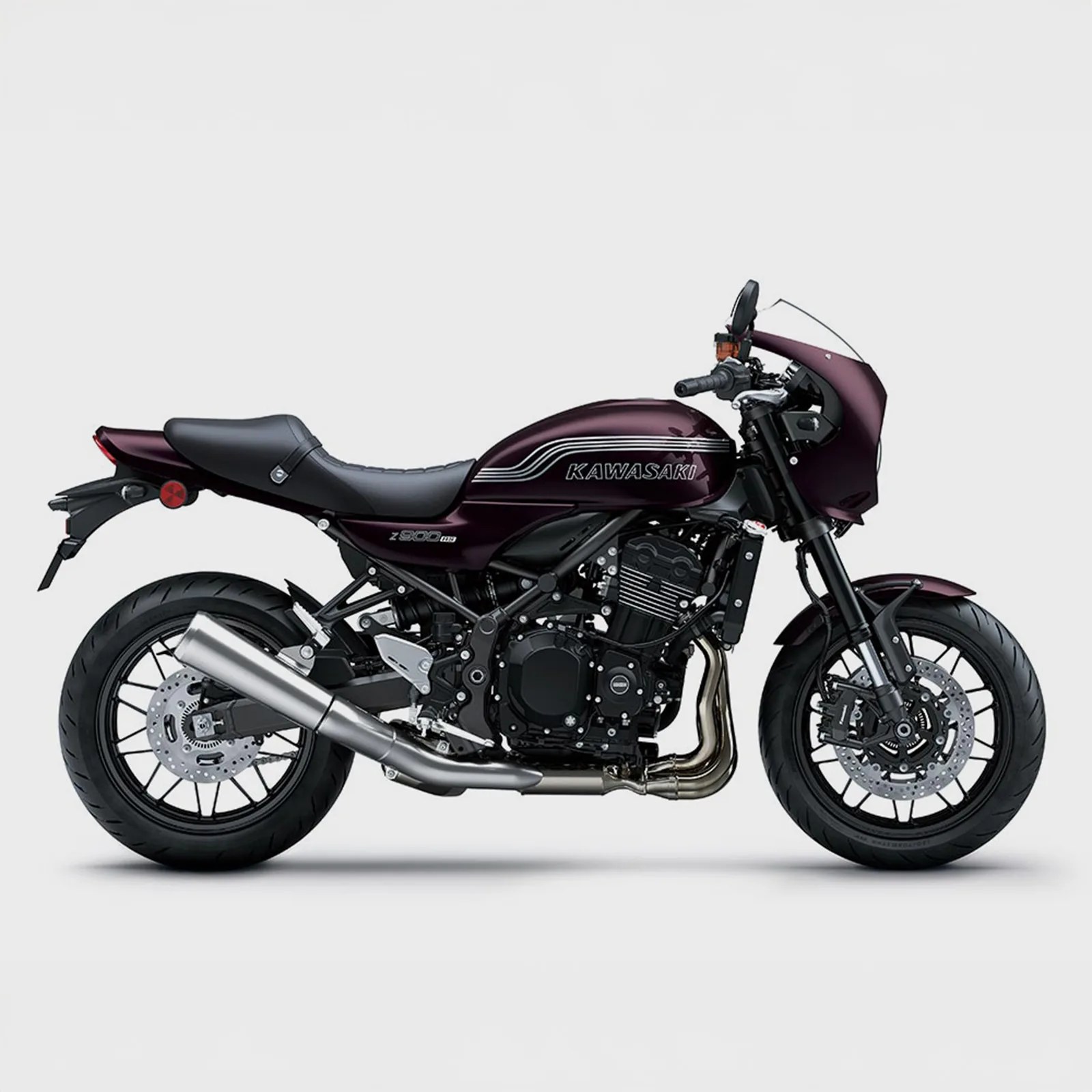 Dark purple Kawasaki Z900RS motorcycle with black seat and silver exhaust on a white background.