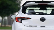 Rear view of a white Toyota Corolla Special Edition hatchback showing taillight, rear window wiper, and badge.