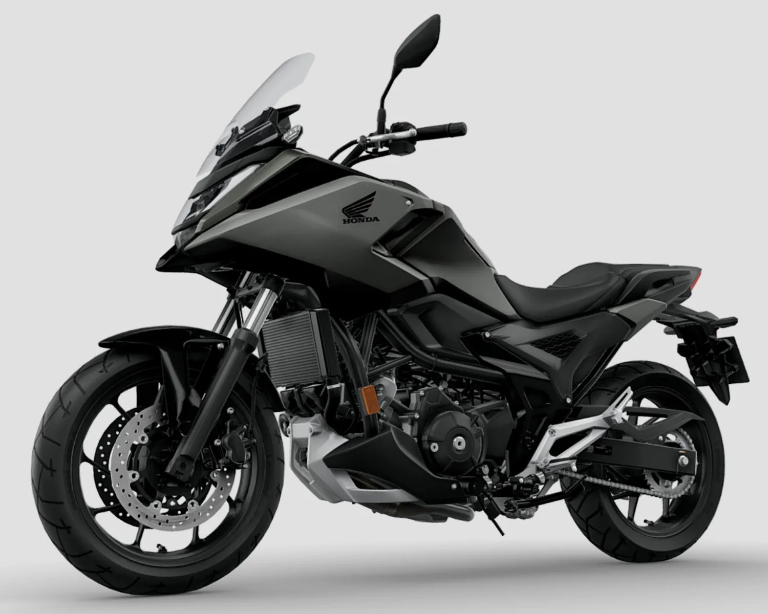 Matte black Honda motorcycle with windshield, disc brakes, and exposed engine components on a gray background.