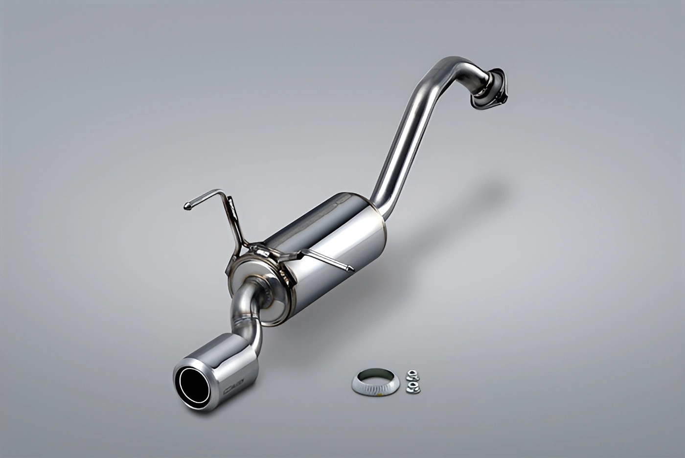 Polished stainless steel car exhaust muffler with curved pipe and mounting hardware on gray background.