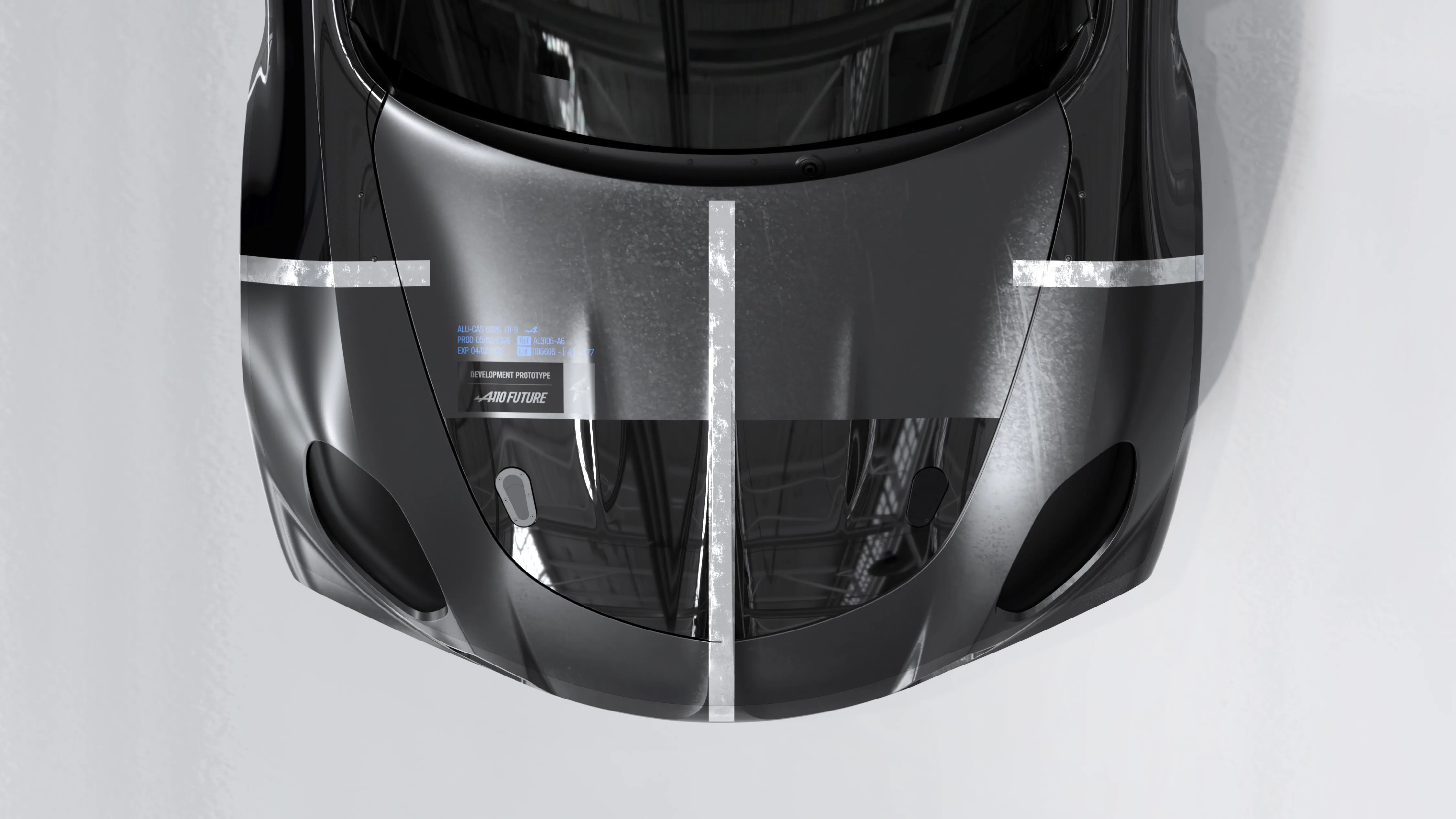 Glossy black car hood with white racing stripes and a "Development Prototype" label.