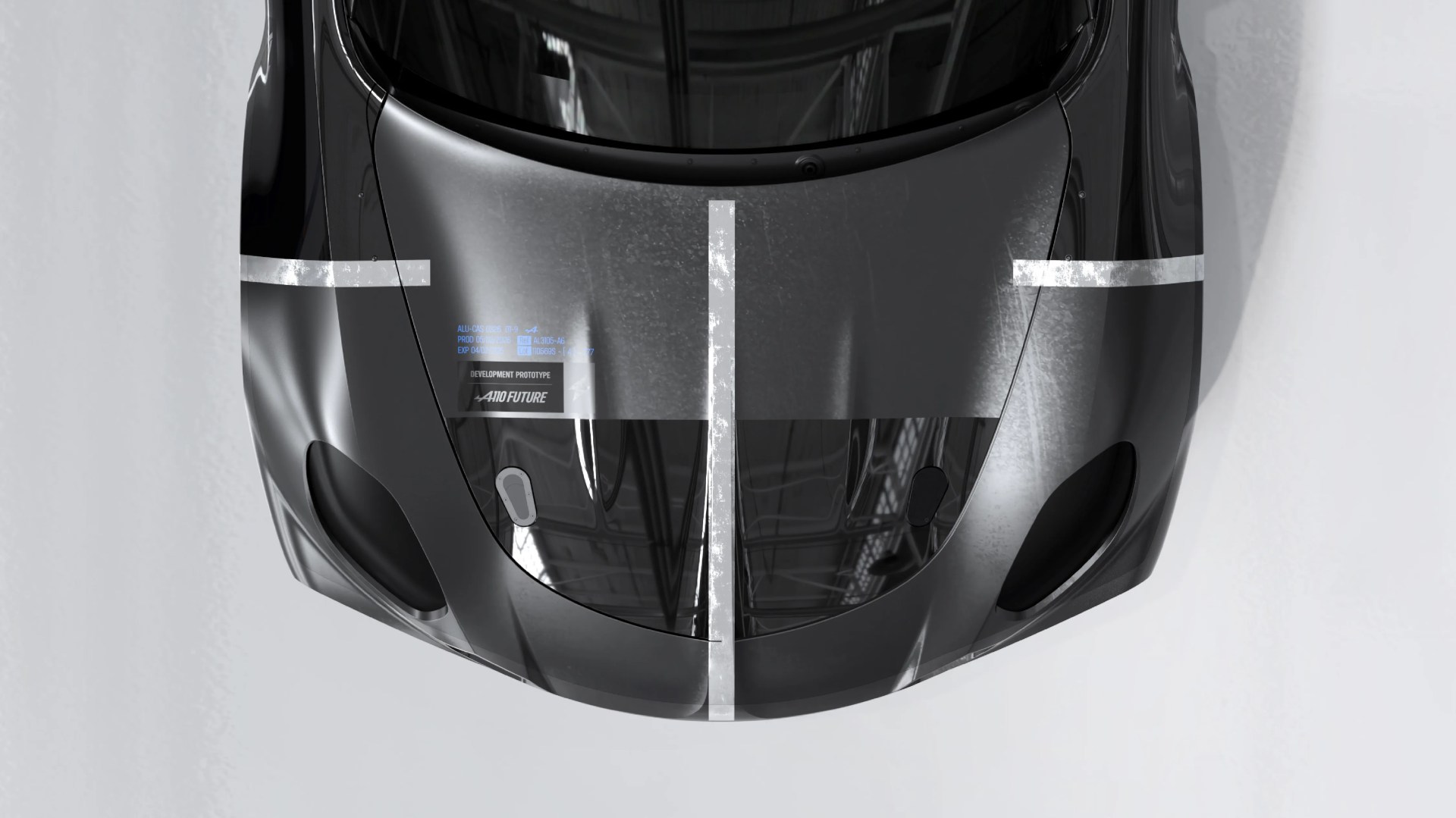Glossy black car hood with white racing stripes and a "Development Prototype" label.