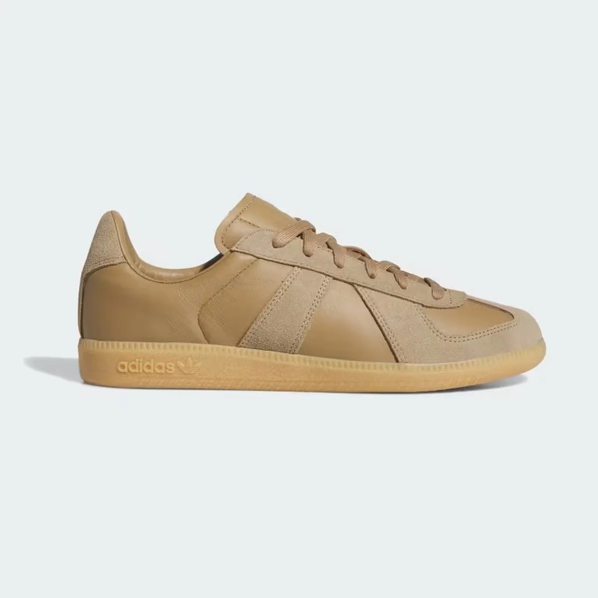 Tan leather and suede Adidas sneaker with gum sole and embossed logo on the side.