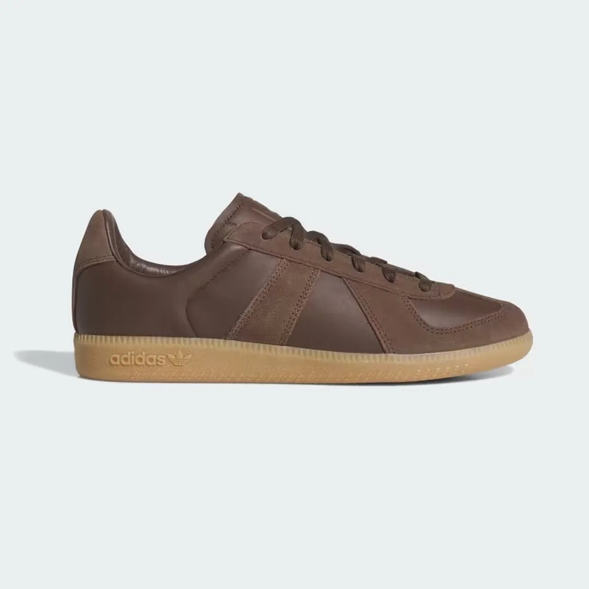 Brown leather Adidas sneaker with gum sole and embossed logo on the side.