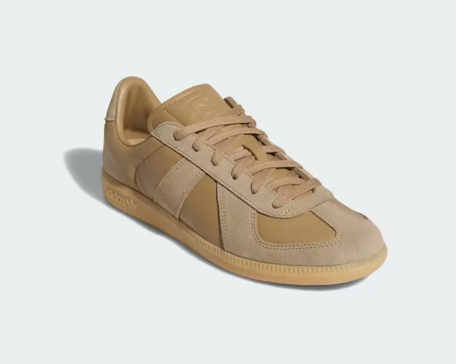 Tan leather and suede Adidas sneaker with tonal laces and gum sole on a light background.