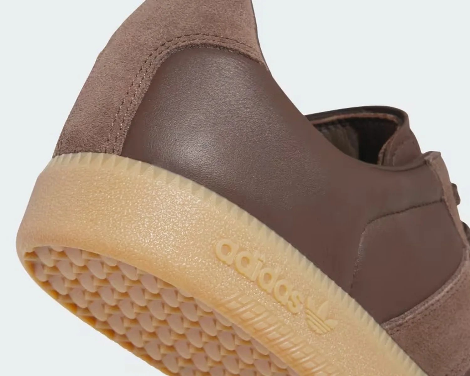 Close-up of the heel and sole of a brown Adidas shoe with a textured gum sole.