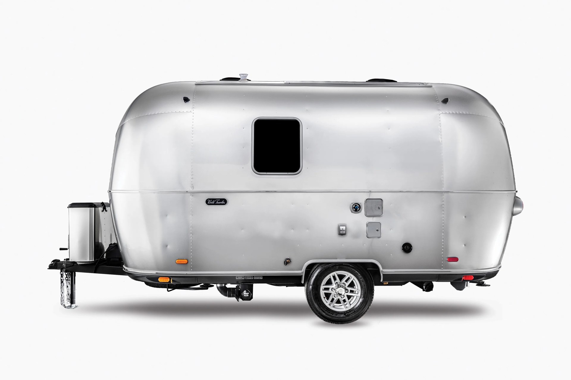 Silver aluminum travel trailer with one window and a single axle wheel on a white background.