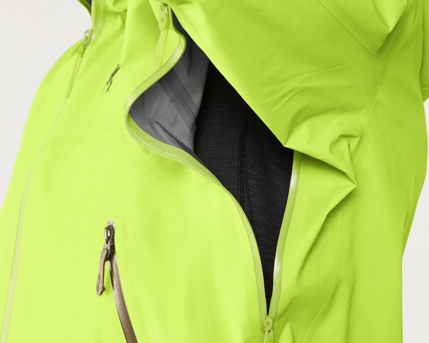 Bright lime green jacket with a partially unzipped underarm ventilation zipper showing black mesh lining.