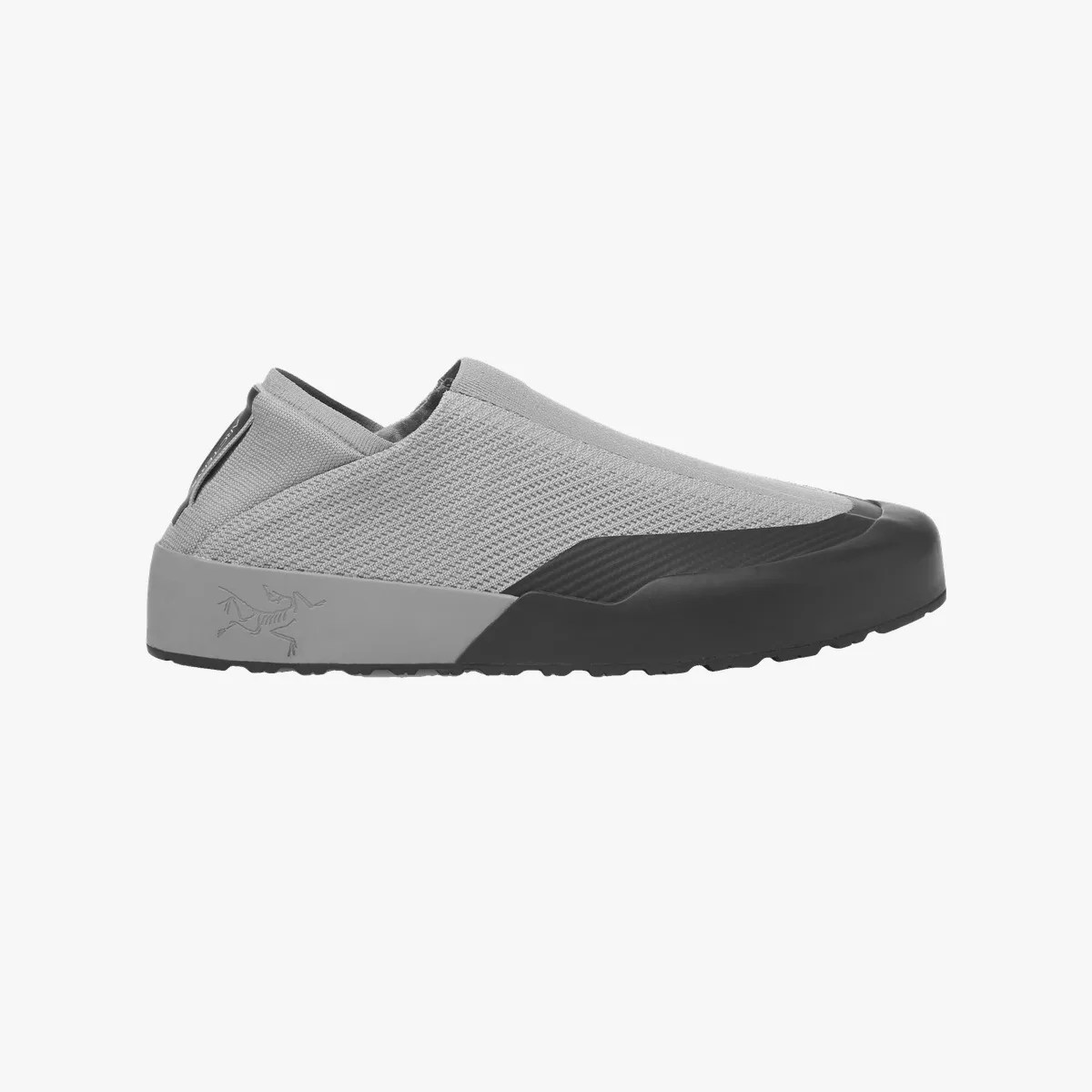 Light gray slip-on sneaker with black toe cap and gray sole featuring a skeletal logo on the heel.