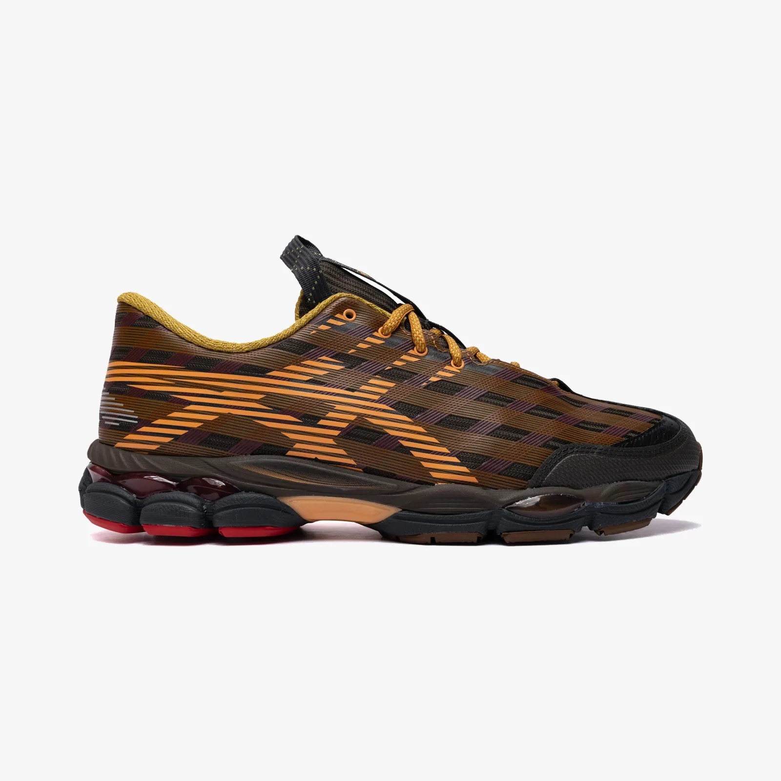 Brown and black athletic shoe with orange stripes and a cushioned black and red sole.