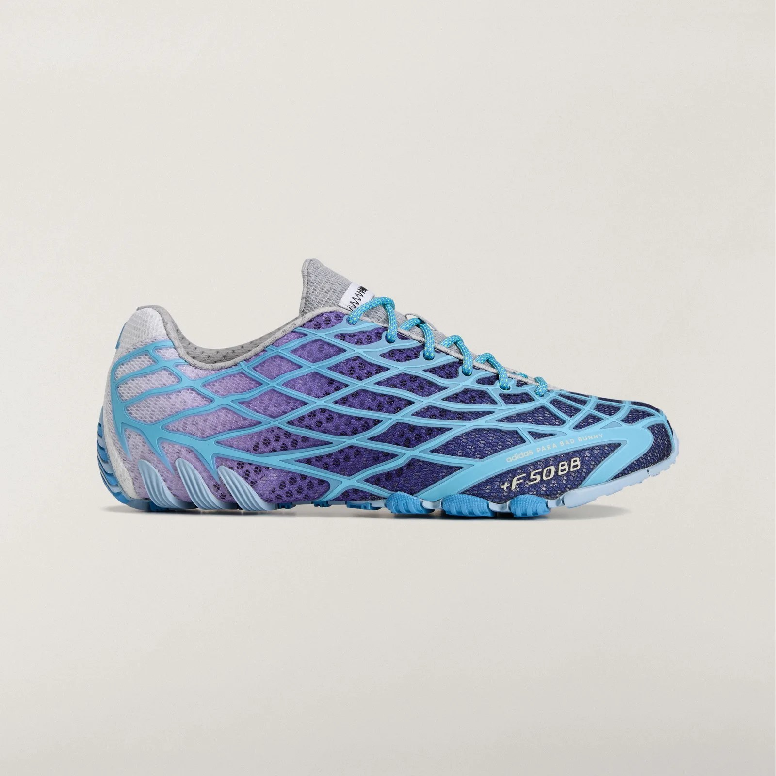 Purple and blue Adidas running shoe with a web-like blue overlay and blue laces on a beige background.