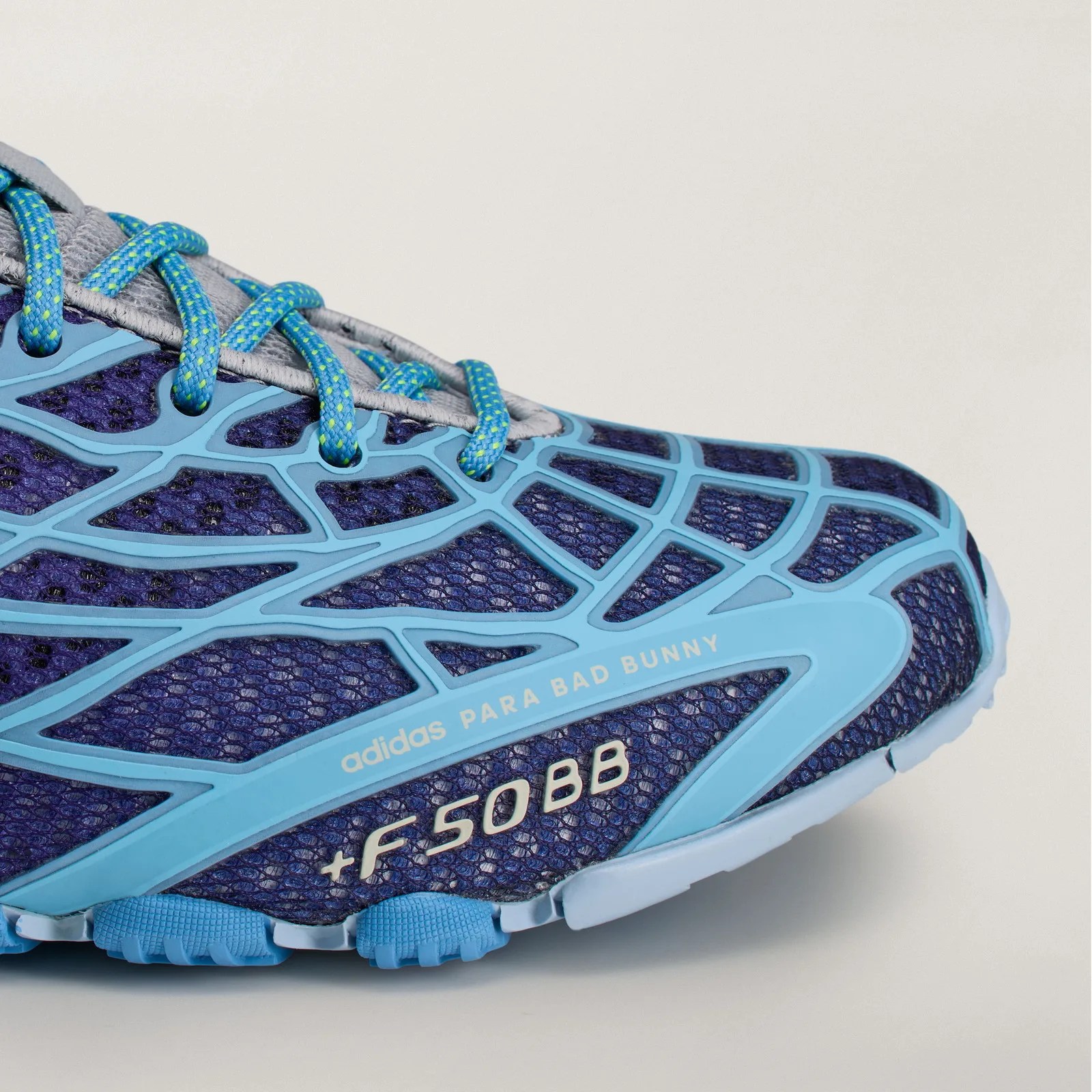 Close-up of a blue and light blue Adidas sneaker with "adidas PARA BAD BUNNY" and "+F50 BB" text on the side.