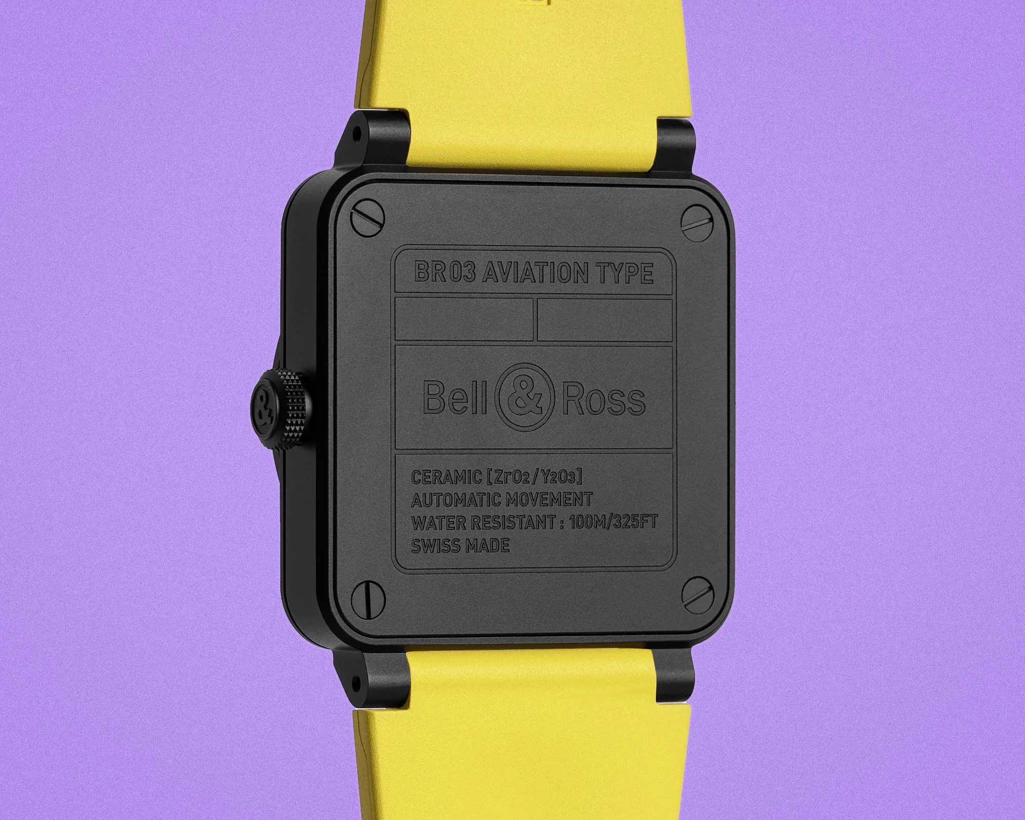 Back of a black Bell & Ross BR03 Aviation Type watch with yellow strap on purple background.