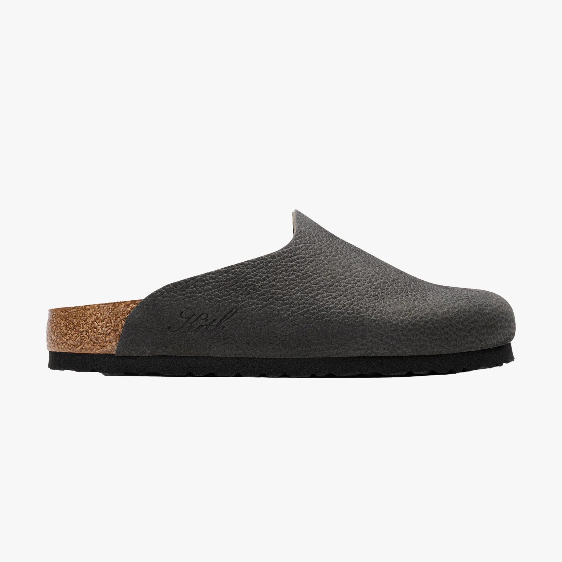 Black textured leather slip-on clog with cork footbed and black sole.