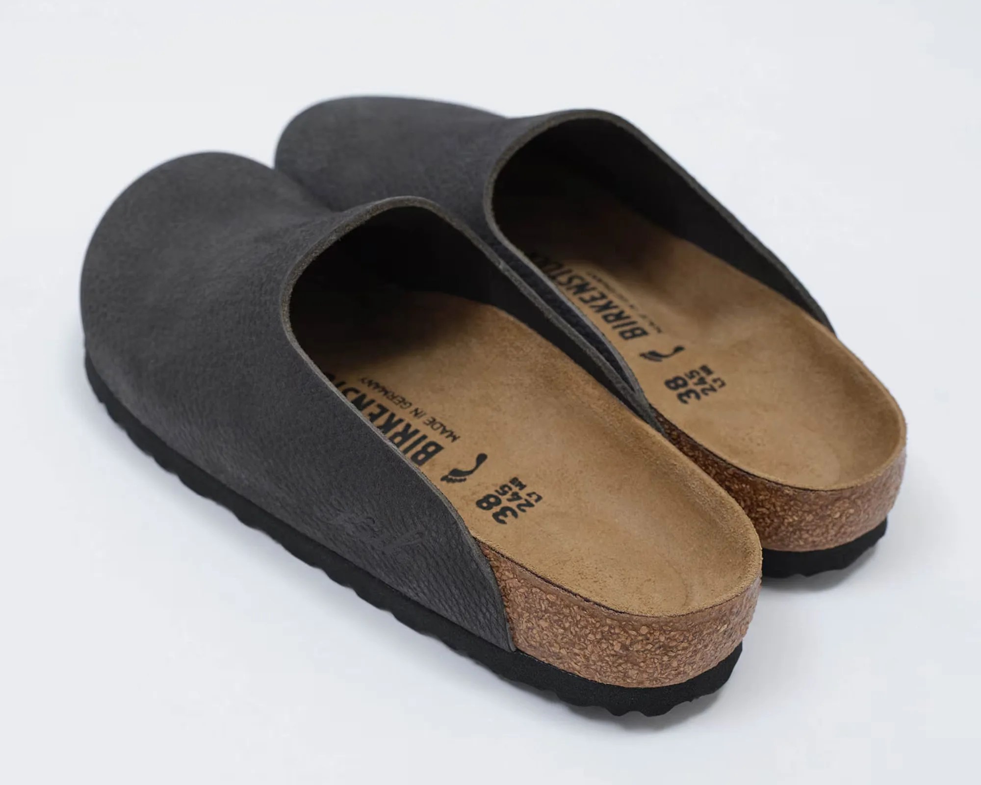 Pair of black Birkenstock slip-on clogs with cork footbeds and black soles on a white background.